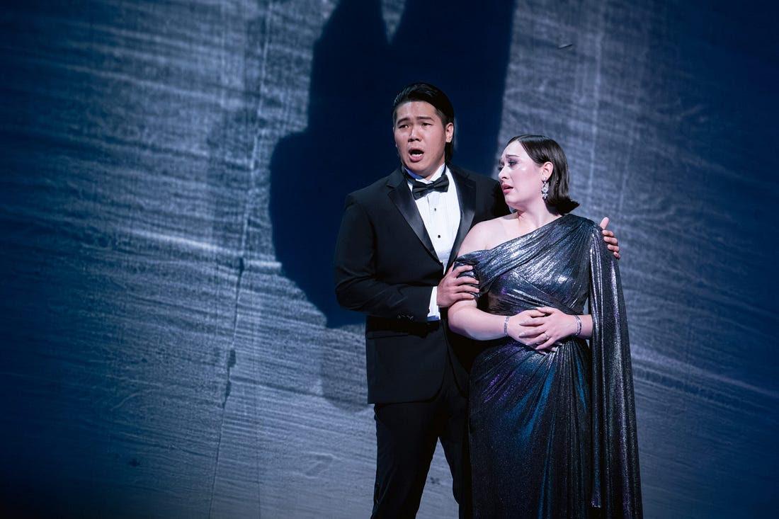 Merola Opera Program production — two singers in formalwear perform against a moonlit backdrop